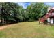 Lush backyard with mature trees and landscaping that provides a serene, private outdoor space at 3885 Lake Juliette Dr, Buford, GA 30519