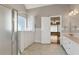 Bathroom with double vanity, walk-in shower and jacuzzi tub with large window at 3885 Lake Juliette Dr, Buford, GA 30519