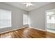Bedroom with hardwood floors, light-grey walls and connecting bathroom at 3885 Lake Juliette Dr, Buford, GA 30519