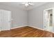 This bedroom has neutral walls, hardwood flooring, and a full closet at 3885 Lake Juliette Dr, Buford, GA 30519
