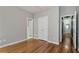 This bedroom has neutral walls, hardwood flooring, and a double door closet at 3885 Lake Juliette Dr, Buford, GA 30519