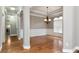 Elegant dining room with hardwood floors, modern chandelier, and decorative wainscoting at 3885 Lake Juliette Dr, Buford, GA 30519