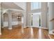 Open-concept foyer with hardwood floors, elegant lighting, and neutral paint at 3885 Lake Juliette Dr, Buford, GA 30519