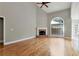 Spacious living room with hardwood floors, fireplace, and large windows at 3885 Lake Juliette Dr, Buford, GA 30519