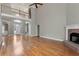 Grand living room featuring a fireplace, two-story ceilings, and hardwood floors at 3885 Lake Juliette Dr, Buford, GA 30519