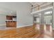 Open-concept living room with hardwood floors, kitchen access, and staircase at 3885 Lake Juliette Dr, Buford, GA 30519
