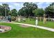 Community playground area with swings, slide, and play equipment, surrounded by lush greenery at 3885 Lake Juliette Dr, Buford, GA 30519
