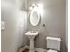 Powder room features a pedestal sink, an oval mirror and bronze fixtures at 3885 Lake Juliette Dr, Buford, GA 30519