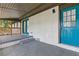 Covered back porch with teal door, brick siding, and access to outdoor living space at 4345 Sasanqua Ct, Tucker, GA 30084