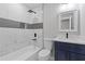 Modern bathroom featuring a tiled shower, a navy blue vanity, and sleek fixtures at 4345 Sasanqua Ct, Tucker, GA 30084