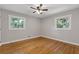 Bright bedroom featuring hardwood floors, a ceiling fan, and plenty of natural light at 4345 Sasanqua Ct, Tucker, GA 30084