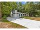 A single-story house with a white brick exterior, accented by a long driveway leading to the property at 4345 Sasanqua Ct, Tucker, GA 30084