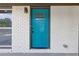 Close up showcasing the property's entrance featuring a blue door and white brick surround at 4345 Sasanqua Ct, Tucker, GA 30084