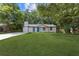 Charming single-story home featuring a well-manicured lawn and a striking blue front door at 4345 Sasanqua Ct, Tucker, GA 30084