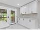 Kitchen featuring white cabinetry, modern countertop, and double french doors leading to a porch at 4345 Sasanqua Ct, Tucker, GA 30084