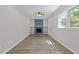 Bright living room featuring a blue brick fireplace, built-in shelves, and light wood flooring at 4345 Sasanqua Ct, Tucker, GA 30084