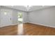 Bright living room showcasing hardwood floors, a modern light fixture, and neutral wall paint at 4345 Sasanqua Ct, Tucker, GA 30084