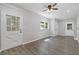 Sun-filled living room showcasing light gray walls, wood floors, and a glass paneled door at 4345 Sasanqua Ct, Tucker, GA 30084