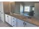 Elegant bathroom offers a double vanity, granite counters, separate shower, and tub at 57 Longhorn Way, Auburn, GA 30011
