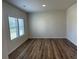 Bedroom featuring large windows, neutral paint and hardwood floors at 57 Longhorn Way, Auburn, GA 30011