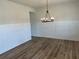 Dining room with wainscotting and a black chandelier overlooking the hardwood floors at 57 Longhorn Way, Auburn, GA 30011