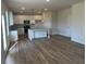 Kitchen boasts stainless steel appliances, island and granite countertops with room for dining area at 57 Longhorn Way, Auburn, GA 30011