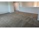 Spacious loft area features neutral paint, plush carpet, and access to two bedrooms at 57 Longhorn Way, Auburn, GA 30011