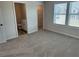 Bedroom boasts carpet, walk-in closet, windows, with an ensuite bathroom at 57 Longhorn Way, Auburn, GA 30011