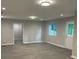Spacious basement area with gray plank flooring, natural light and access to the exterior at 5920 Findley Chase Dr, Johns Creek, GA 30097