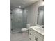 Modern bathroom featuring a walk-in shower with glass door, vanity, and sleek fixtures at 5920 Findley Chase Dr, Johns Creek, GA 30097