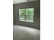 Simple bedroom with a large window overlooking a green landscape, and plush carpeting at 5920 Findley Chase Dr, Johns Creek, GA 30097
