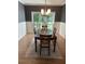 Traditional dining room showcasing a dark wood table, decorative wainscoting and a large window at 5920 Findley Chase Dr, Johns Creek, GA 30097