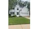 Charming two-story home with a lush green lawn and beautiful, freshly-painted white brick exterior at 5920 Findley Chase Dr, Johns Creek, GA 30097