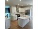 Open kitchen with white cabinets, stainless steel appliances, marble countertops, and a center island at 5920 Findley Chase Dr, Johns Creek, GA 30097