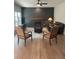 Cozy living room featuring a brick fireplace, dark accent wall and plush leather sofa at 5920 Findley Chase Dr, Johns Creek, GA 30097