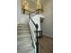 Inviting staircase with neutral carpeting and black and white banister leading to the upper level at 5920 Findley Chase Dr, Johns Creek, GA 30097