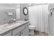Bathroom featuring white vanity, chrome fixtures, and shower with curtain at 140 Discovery Lake Dr, Fayetteville, GA 30215