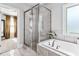 Bathroom with a glass enclosed shower, tub, and neutral walls at 140 Discovery Lake Dr, Fayetteville, GA 30215