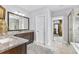 Bathroom features granite countertops, a dark vanity, a doorway to an ensuite bathroom, and a glass shower at 140 Discovery Lake Dr, Fayetteville, GA 30215