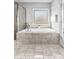 This elegant bathroom showcases a soaking tub with tile surround and a separate glass enclosed shower at 140 Discovery Lake Dr, Fayetteville, GA 30215