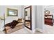 Sitting area in bedroom features a chaise lounge beneath framed artwork, plus a full-length mirror at 140 Discovery Lake Dr, Fayetteville, GA 30215