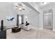 Spacious bonus room features neutral walls and carpet, and a leather ottoman at 140 Discovery Lake Dr, Fayetteville, GA 30215