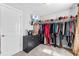Walk-in closet with hanging clothes, shoe racks, and neutral walls at 140 Discovery Lake Dr, Fayetteville, GA 30215