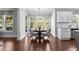Bright dining area with hardwood floors and backyard views, adjacent to the kitchen at 140 Discovery Lake Dr, Fayetteville, GA 30215