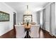 Dining room features a large mirror, chandelier lighting, and seating for eight at 140 Discovery Lake Dr, Fayetteville, GA 30215