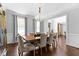 Formal dining room with hardwood floors, chandelier lighting, and views into other rooms at 140 Discovery Lake Dr, Fayetteville, GA 30215