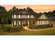 Handsome two-story home with classic design elements, manicured lawn, and a charming front porch at 140 Discovery Lake Dr, Fayetteville, GA 30215