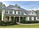 Stunning two-story home with beautiful landscaping and a welcoming covered front porch with stone accents at 140 Discovery Lake Dr, Fayetteville, GA 30215
