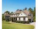 Charming home on a lush green lawn; features a side-entry garage and manicured landscaping at 140 Discovery Lake Dr, Fayetteville, GA 30215