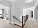 Upstairs hallway with carpeted flooring, crown molding, and views of bedrooms at 140 Discovery Lake Dr, Fayetteville, GA 30215
